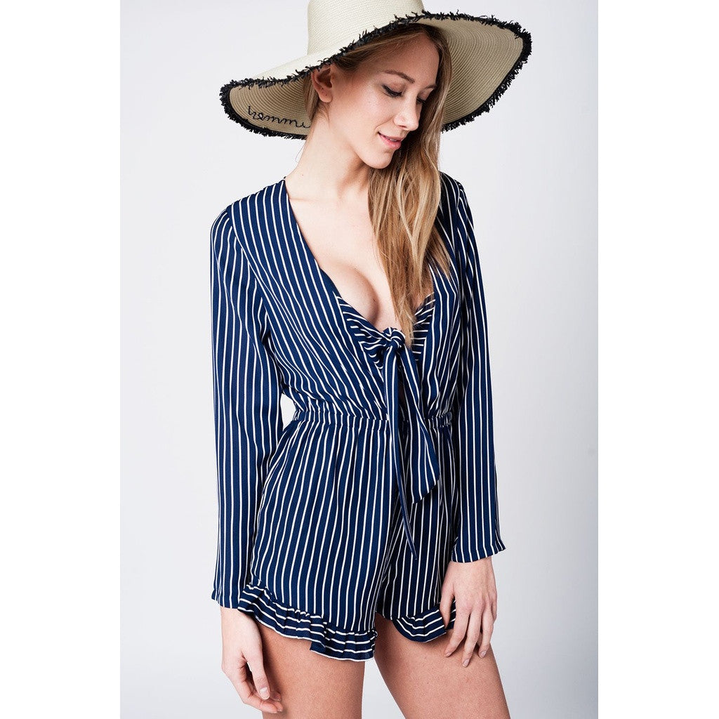 Navy striped romper with deep neckline and bow detail